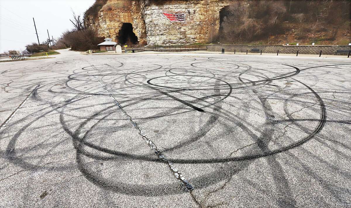 The parking lot of Piasa Park was showing signs Thursday of being used as a place to do donuts and drift cars, with car tire rubber leaving marks all over the lot. The park has seen acts of vandalism in recent years including the breaking of the marker last week that told visitors the Native American legend behind the bluff painting. The park, located on the northwestern edge of Alton off the Great River Road, has also had problems with spray paint graffiti.