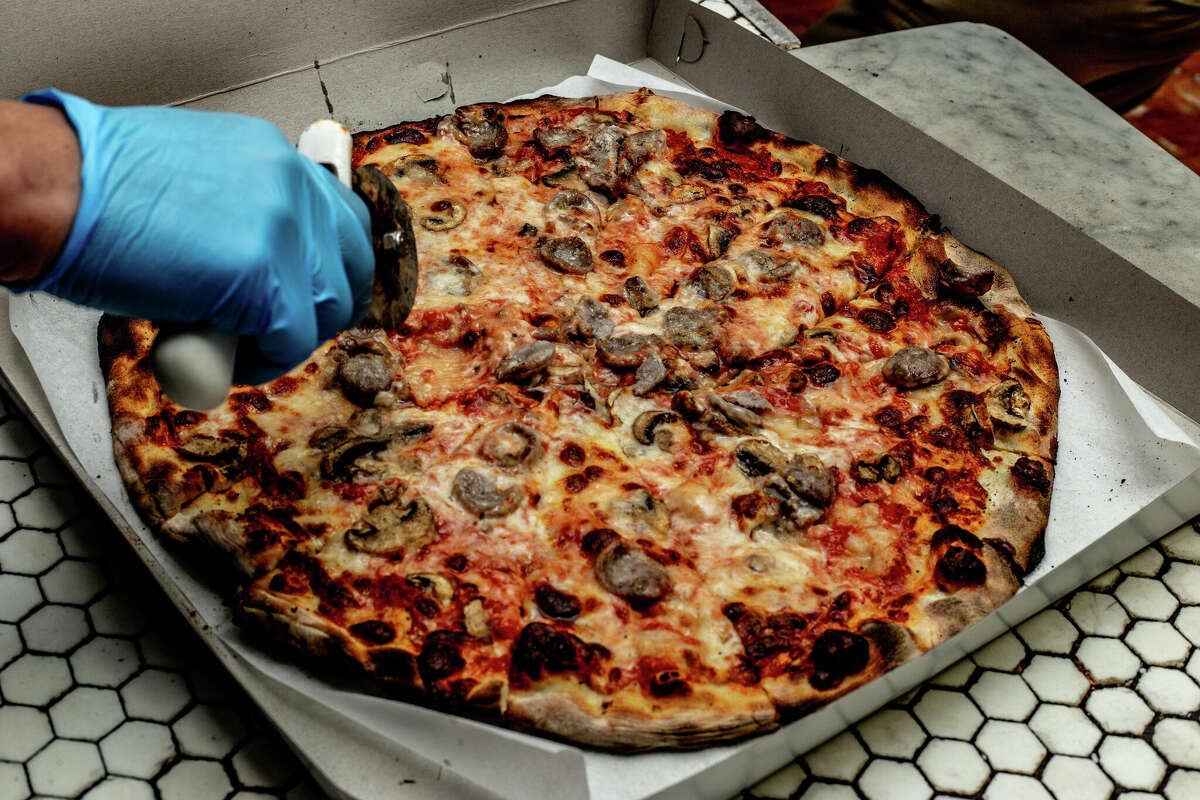 Hot pizza getting cut and boxed at Frank Pepe's in New Haven on April 23, 2021.