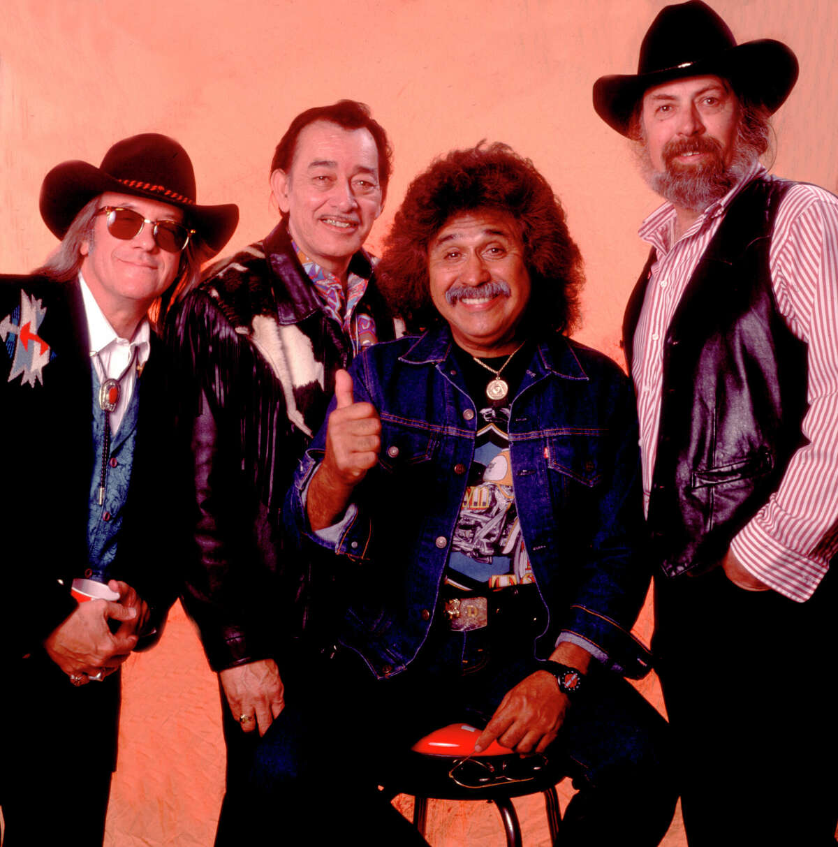 Portrait of the members of American Tejano group Texas Tornados as they pose backstage at the Farm Aid benefit concert, Dallas, Texas, March 14, 1992. Pictured are Doug Sahm, Flaco Jimenez, Freddie Fender, and Augie Myers. (Photo by Paul Natkin/Getty Images)