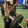 Aaron Garrett, owner and head trainer of 409 Fit in Silsbee, demonstrates how to work the deltoid using a barbell on Thursday, March 16, 2023.