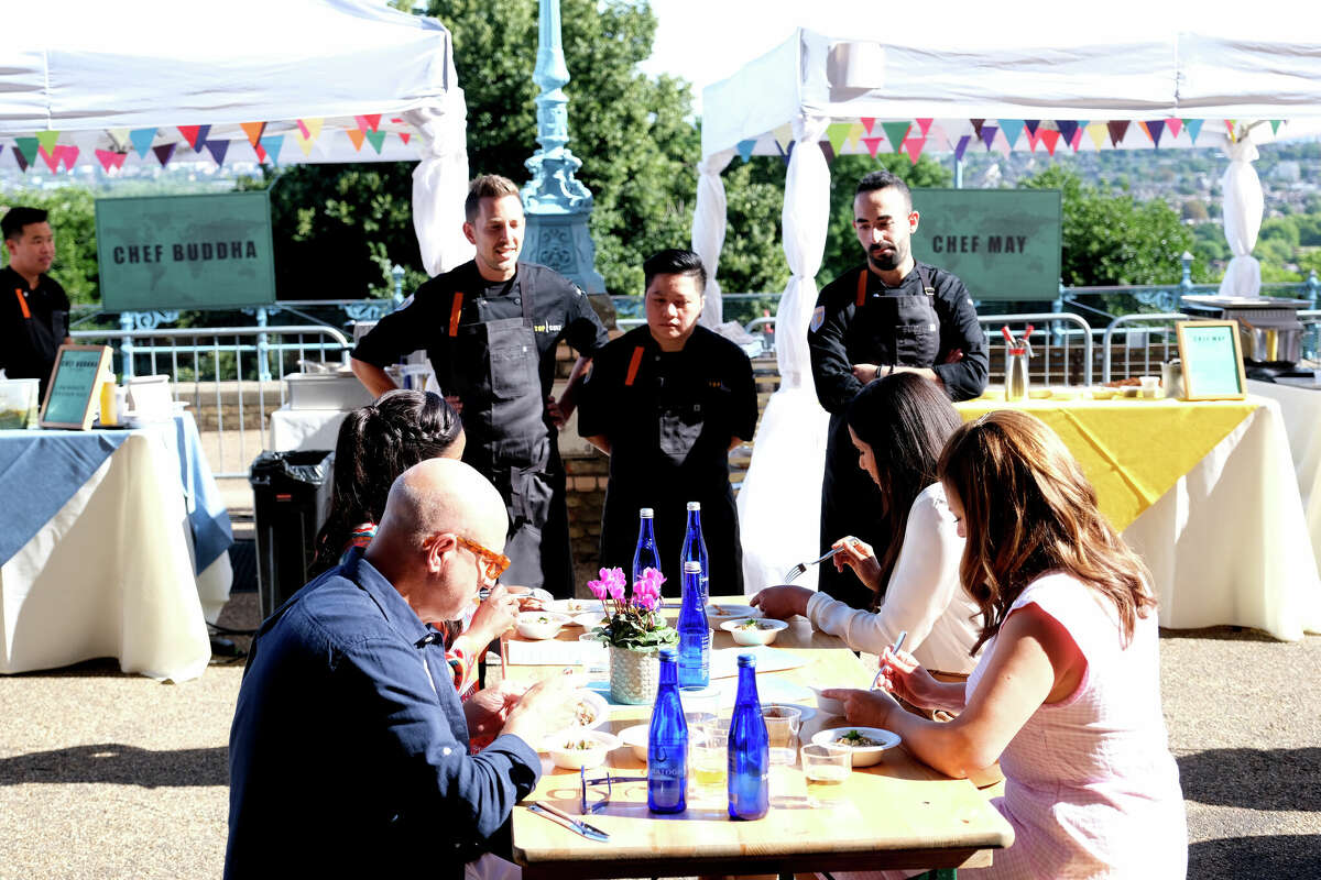 Contestants on the new season of the Bravo cooking series "Top Chef" face a table of judges including, counterclockwise from bottom left, Tom Colicchio, Gail Simmons and Padma Lakshmi. On the table are iconic blue bottles of Saratoga Spring Water, which, as part of a push to sell the Saratoga-based brand nationwide, is sponsoring the $250,000 grand prize for the season's winner. The 20th season of "Top Chef" started March 9. New episodes air at 9 p.m. Thursday on Bravo and become available the following day on the Peacock streaming service.