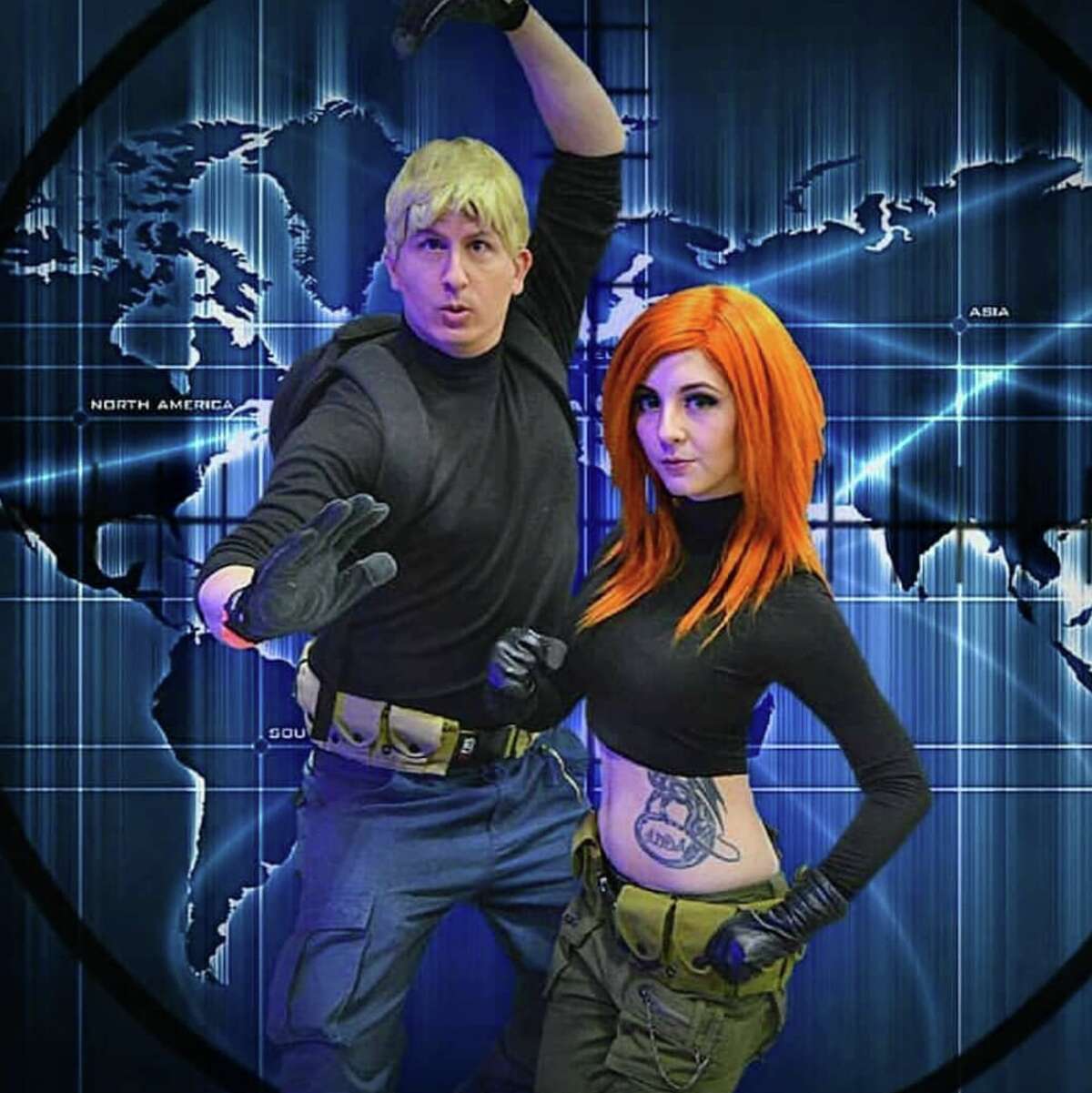 Josh Wilson shows off his Ron Stoppable next to his wife who takes the form of Kim Possible from Kim Possible.