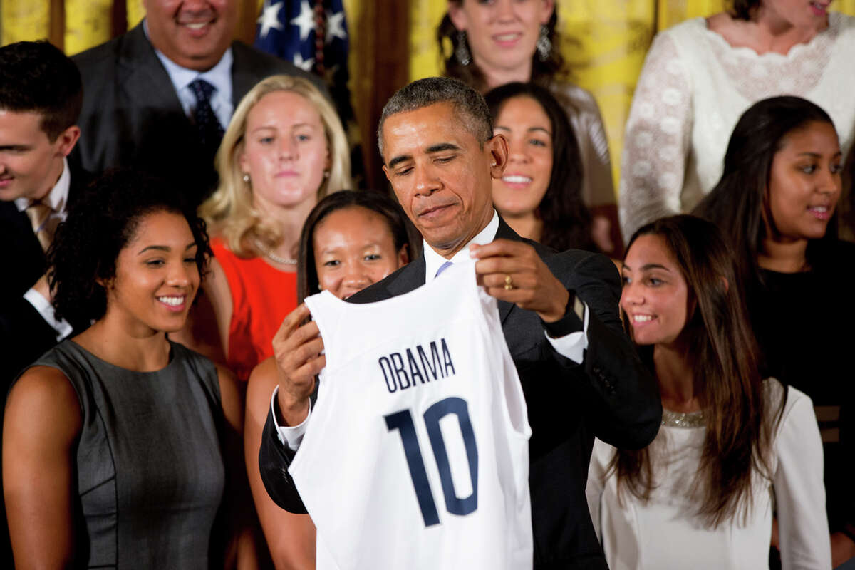 President Barack Obama holds up a UConn Huskies basketball jersey in the East Room of the White House in Washington, Tuesday, Sept. 15, 2015, during a ceremony honoring the 2015 NCAA Womenís Basketball Champion University of Connecticut Huskies. (AP Photo/Andrew Harnik)
