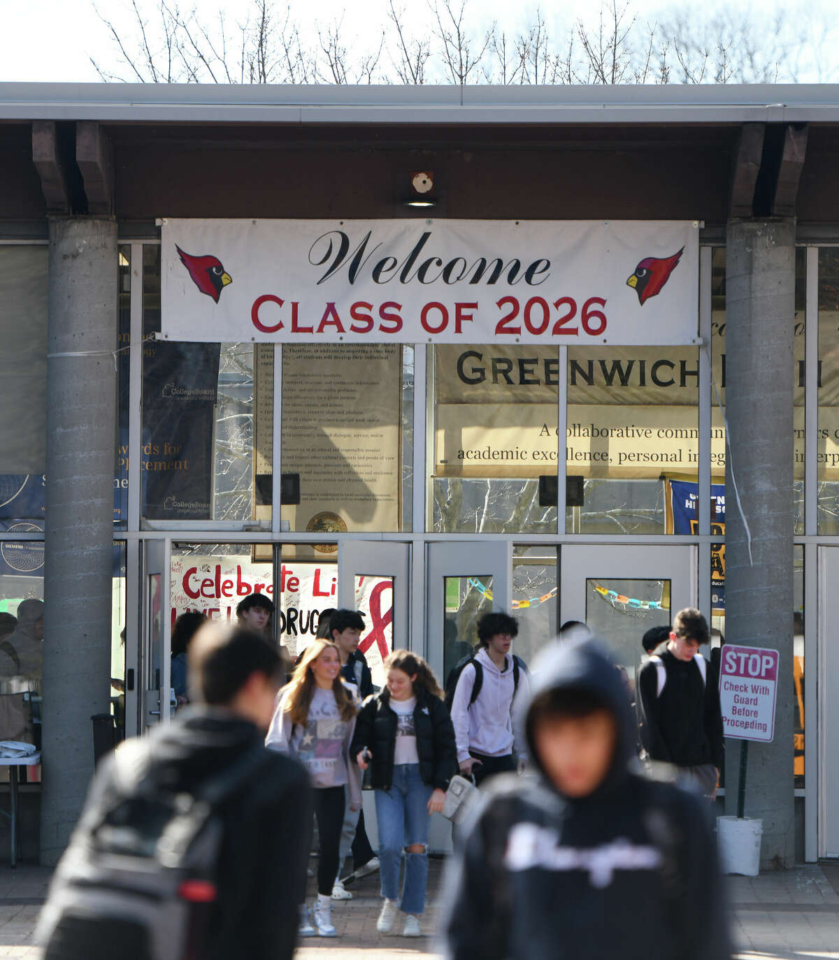 Students exit during dismissal at Greenwich High School in Greenwich, Conn. Tuesday, March 16, 2023.