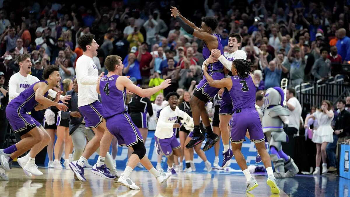 Furman guard JP Pegues, third from right, drilled a game-winning 3-pointer with 2.4 seconds left as the Paladins knocked off fourth-seeded Virginia for the first upset of the NCAA Tournament.