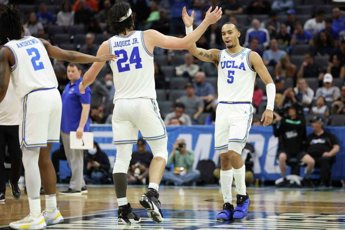 Amari Bailey (5) and Jaime Jaquez Jr. (24) celebrate during of the UCLA's opening NCAA Tournament victory over North Carolina-Asheville on Thursday in Sacramento.