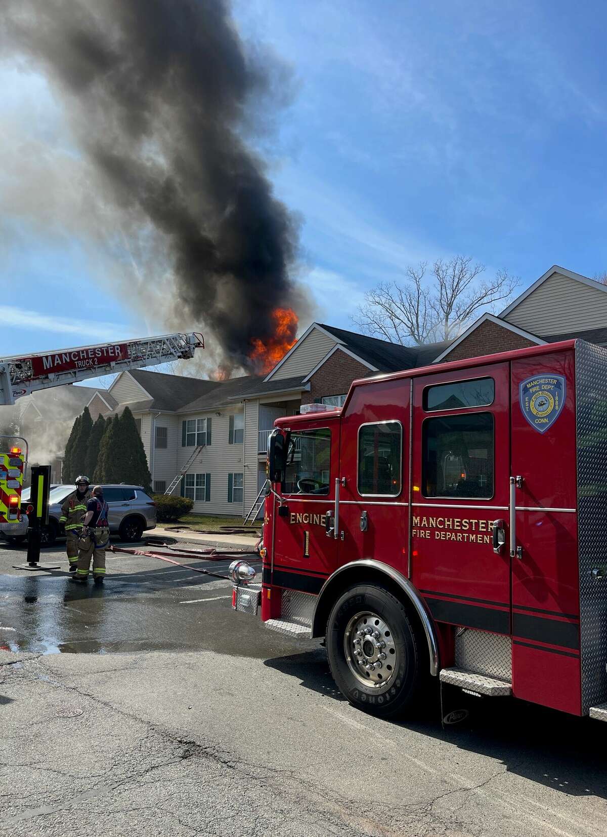 Firefighters battle a blaze at a Manchester apartment complex at 39 Buckland St. Thursday. More than 60 residents were displaced, officials said.