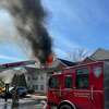 Firefighters battle a blaze at a Manchester apartment complex, 39 Buckland St., Thursday. More than 50 residents were displaced.
