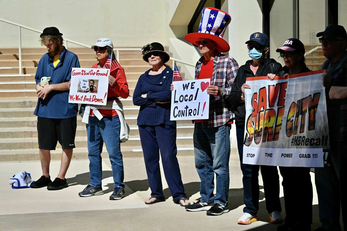 示威者参加新闻发布会，宣布亨廷顿海滩的联邦诉讼反对加州的住房命令。
