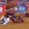 J.D. Struxness was knocked off of his horse after it tripped over a calf during a steer wrestling event at the Houston Rodeo on Monday. 