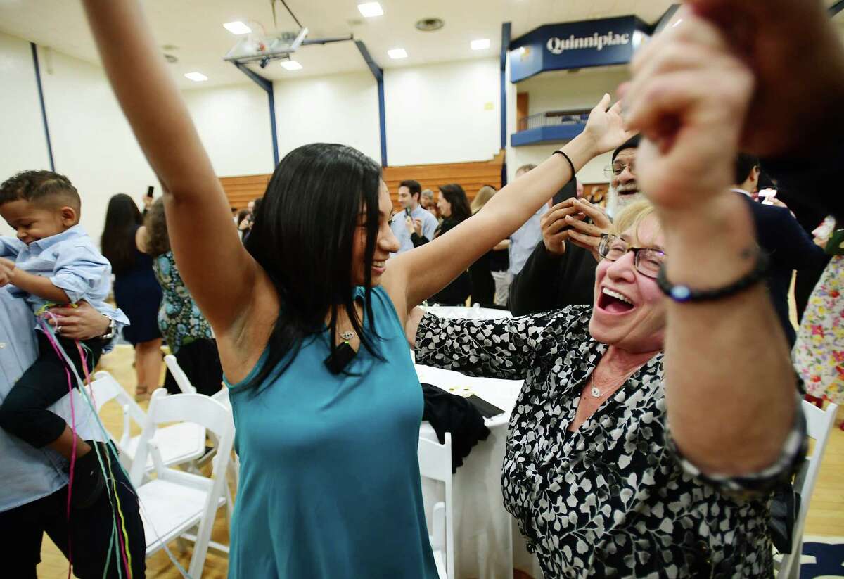 Medical student Christina Nelson, of New Haven, looks to hug her mother, Janice Koonce, as she celebrates her medical residency match with Montefiore Medical Center, in The Bronx, during Match Day at Quinnipiac University in Hamden, Conn on Friday, March 17, 2023. Ninety-six med students received their residency matches during the annual event.