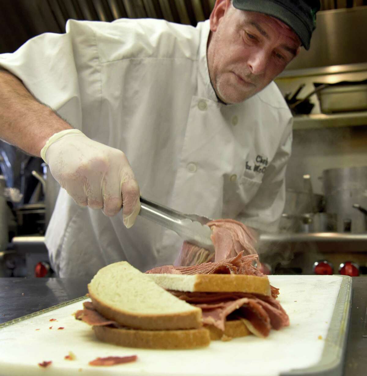 Daniel McCarthy, of Bethel, the chef at the Greater Danbury Irish Cultural Center, makes corned beef sandwiches for a lunch crowd Friday, March 17, 2023, St. Patrick’s Day.