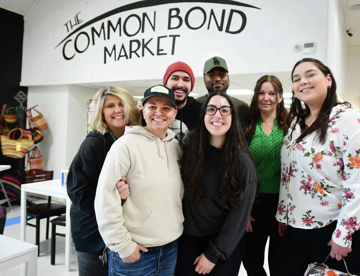 From left; Common Bond Market employees Theresa DeBenedetto, Diana Maione, Christian Hamilton, Hannah Brighindi, Angus Mondesir, Natalie Glidden, and Sabrina Amorando are banding together to try to keep the market open at 40 Huntington Street in Shelton, Conn. on Friday, March 17, 2023.