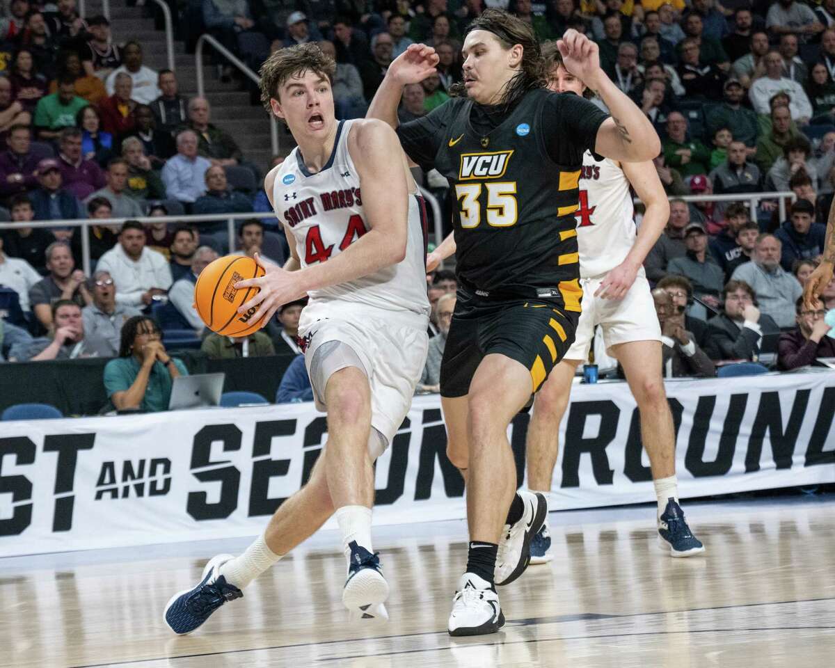 Saint Mary’s senior Alex Ducas drives to the basket in front of Virginia Commonwealth University senior David Schriver at the MVP Arena on Friday, March 17, 2023, in Albany NY.