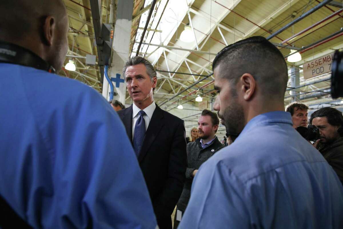 Gov. Gavin Newsom speaks with inmates at a press conference at San Quentin State Prison Friday. Newsom announced plans to convert the prison into a rehabilitation and education center.