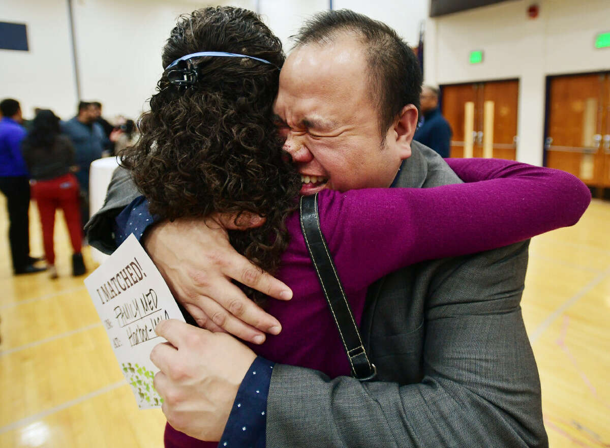 Medical student Phillipe Labrias, of Milford, hugs his professor, Dr. Maureen Helgren, after receiving his medical residency match with UCLA Medical Center in Los Angeles, CA, during Match Day at Quinnipiac University in Hamden, Conn on Friday, March 17, 2023. Ninety-six med students received their residency matches during the annual event.