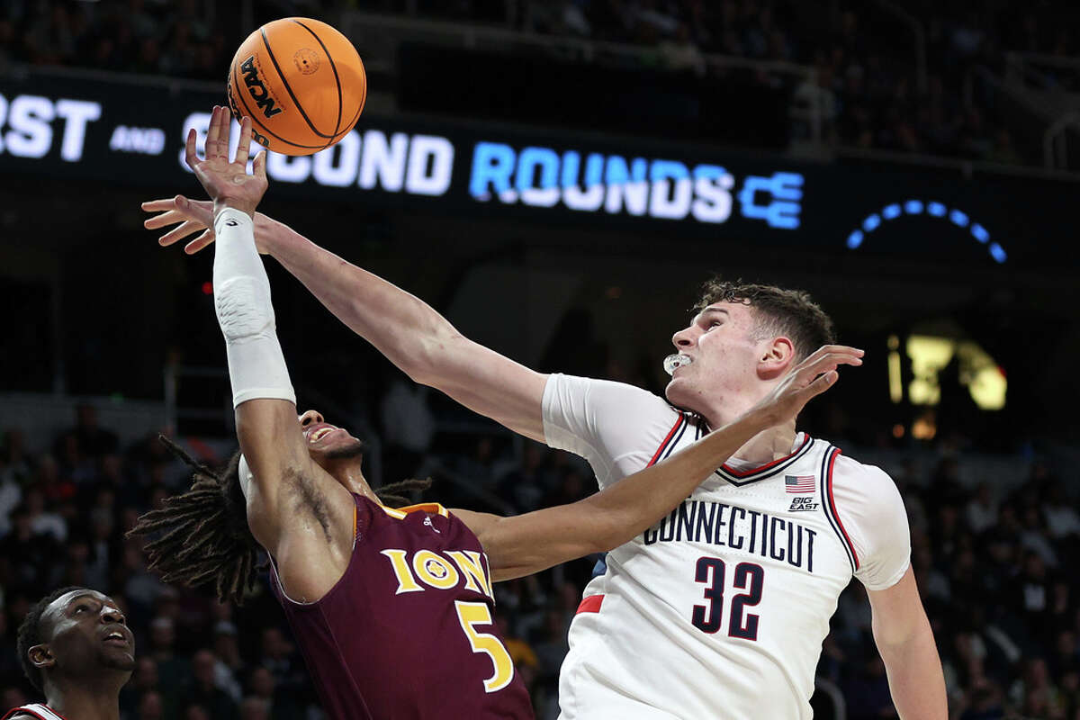 ALBANY, NEW YORK - MARCH 17: Daniss Jenkins #5 of the Iona Gaels goes up with the ball against Donovan Clingan #32 of the Connecticut Huskies in the second half during the first round of the NCAA Men's Basketball Tournament at MVP Arena on March 17, 2023 in Albany, New York. (Photo by Rob Carr/Getty Images)