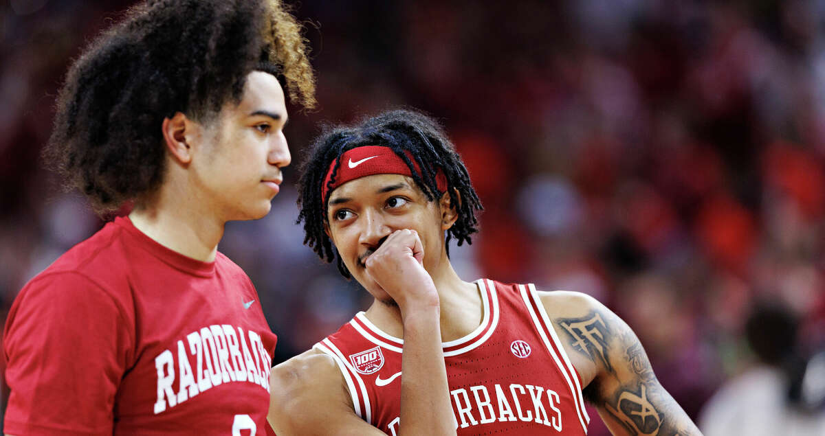 Nick Smith Jr. #3 talks with Anthony Black #0 of the Arkansas Razorbacks warms up before a game against the Florida Gators at Bud Walton Arena on February 18, 2023 in Fayetteville, Arkansas. The Razorbacks defeated the Gators 84-65. (Photo by Wesley Hitt/Getty Images)