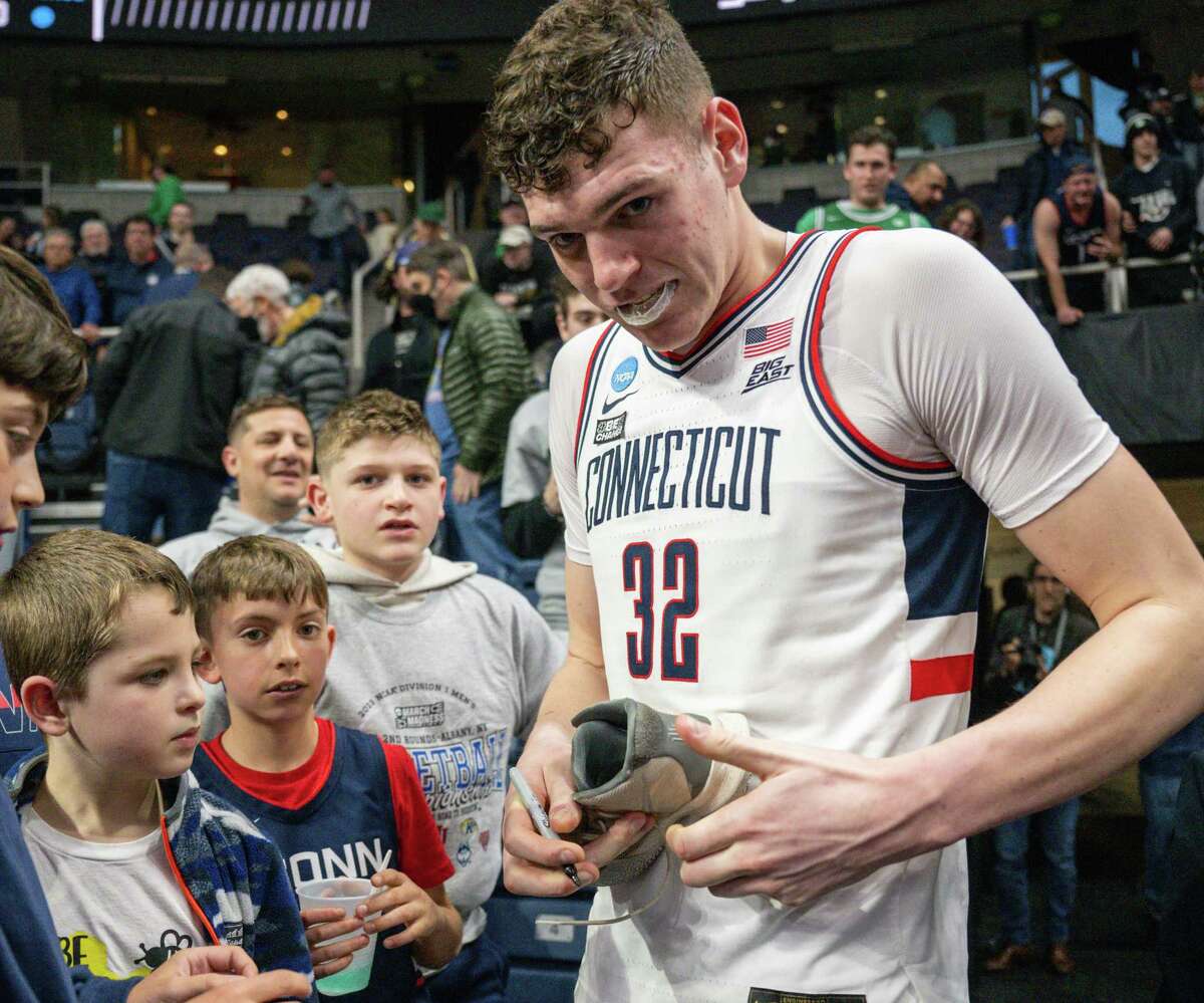 UConn freshman Donovan Clingan signs autographs after his team beat Iona in the first round of the NCAA tournament on Friday, March 17, 2023, at the MVP Arena in Albany, NY.