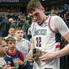 UConn freshman Donovan Clingan signs autographs after his team beat Iona in the first round of the NCAA tournament on Friday, March 17, 2023, at the MVP Arena in Albany, NY.