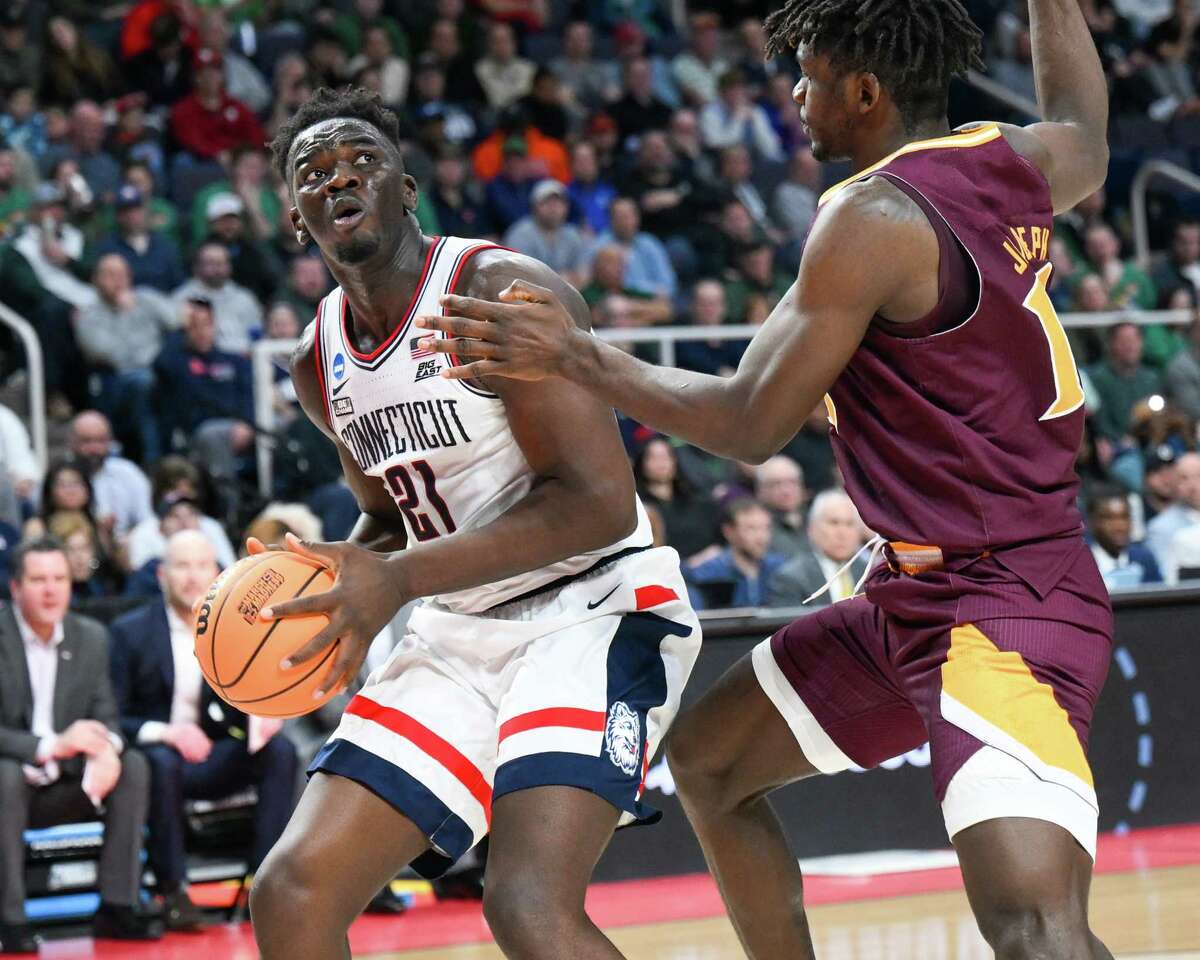 UConn junior Adama Sanogo, a 6-9 forward, drives to the basket against Iona on Friday. Sanogo had 28 points in 13 rebounds in the first-round win.