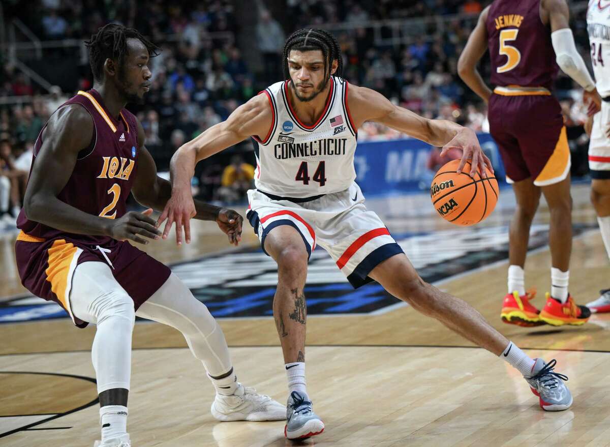 UConn junior and Albany Academy grad Andre Jackson Jr. dribbles up court in front of Iona freshman Sadiku Ibine Ayo during the first round of the NCAA tournament on Friday, March 17, 2023, at the MVP Arena in Albany, NY.