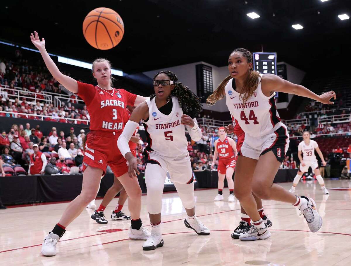 Stanford’s Fran Belibi (5) and Kiki Iriafen (44) and Sacred Heart’s Amelia Wood watch the ball go out of bounds Friday.