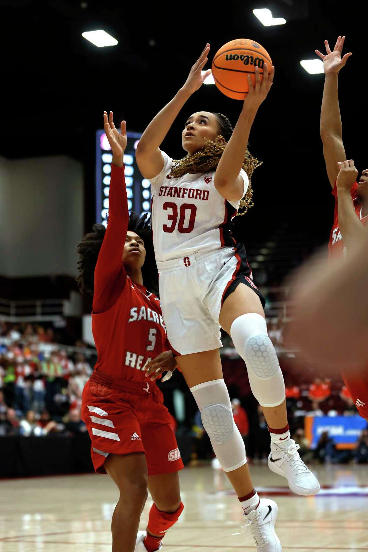 Stanford guard Haley Jones (30) drives to the basket against Sacred Heart guard Wil'Lisha Jackson, left, during the first half of a first-round college basketball game in the women's NCAA Tournament in Stanford, Calif., Friday, March 17, 2023.