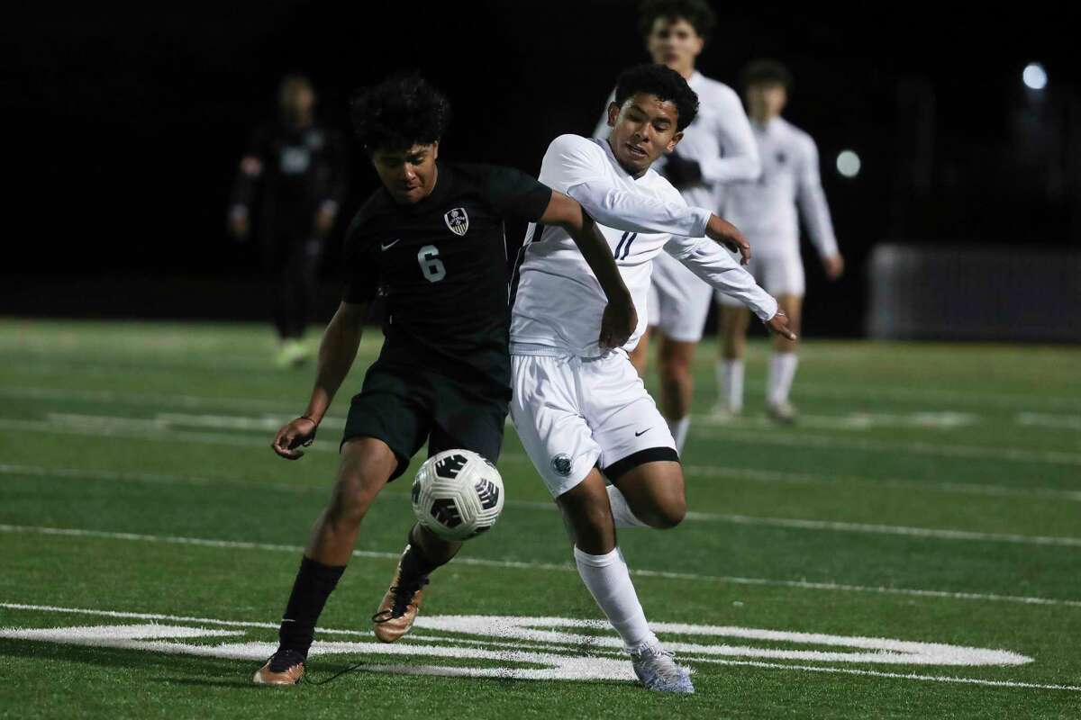 Conroe’s Maynor Ramos (6) battles for the ball against College Park's Eduin Funez (11) during the second half of a District 13-6A high school soccer match at Conroe High School, Friday, March 17, 2023, in Conroe.