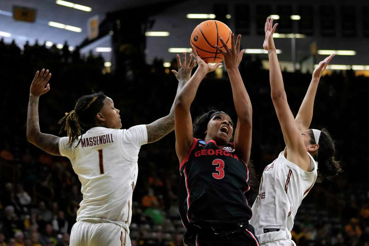 Georgia guard Diamond Battles, middle, drives to the basket between Florida State guard Jazmine Massengill, left, and guard Taylor O'Brien. The Bulldogs won against the shorthanded Seminoles and will face No. 2 seed Iowa.