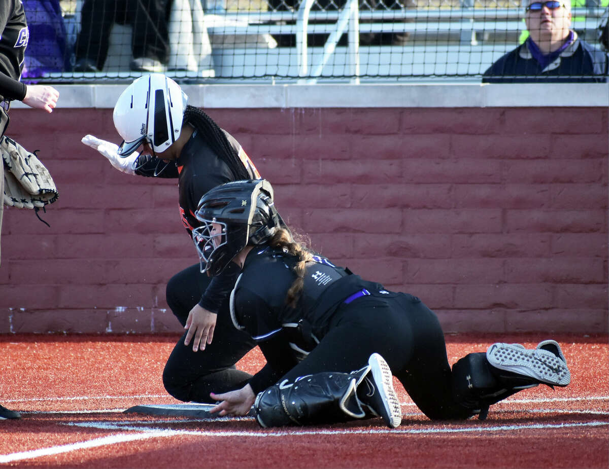 Edwardsville's Zoie Boyd scores on a wild pitch in the fourth against Breese Central on Friday at Plummer Family Park in Edwardsville.