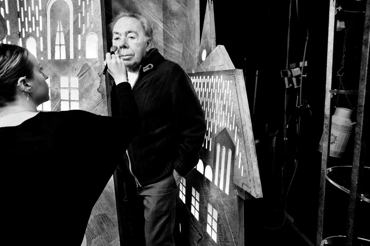 Surrounded by props from his latest musical, "Bad Cinderella," Andrew Lloyd Webber prepares to have his portrait taken at the Imperial Theatre.