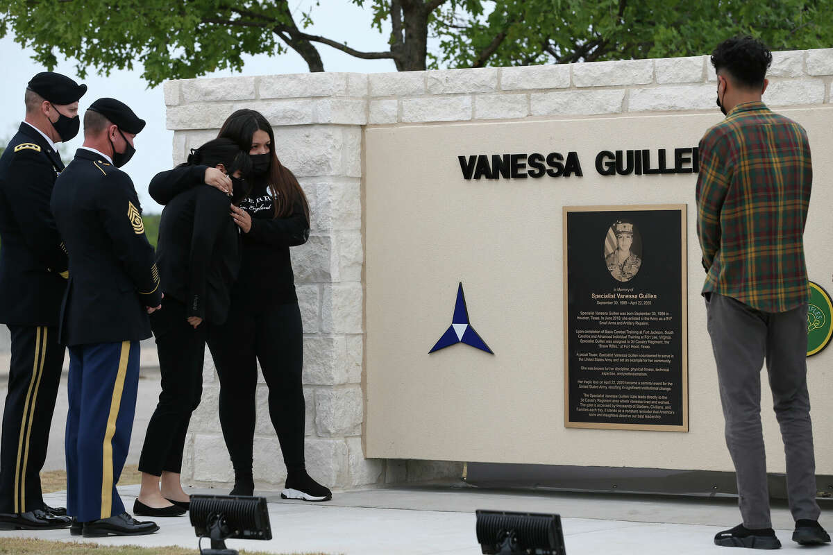 Lupe Guillen, left, hugs her sister, Mayra, during as the Army dedicates a gate in honor of their sister, PFC Vanessa Guillen, at Fort Hood, Texas, Monday, April 19, 2021. Guillen was a soldier at the fort when she was murdered last year. Her death has sparked a national outrage, congressional hearings and legislation that aims to stop sexual harassment and assault on military bases. On the right is the soldier’s fiancé, Juan Cruz. On the left is Fort Hood commander, Lt. Gen. Pat White and Command Sgt. Maj. Arthur “Cliff” Burgoyne, Jr.