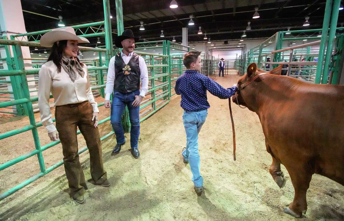 Dana Barton, left, and Tony Bradfield, part of the Rodeo Auction Angels watch kids and their steers backstage during the Junior Market Steer Auction at the Houston Livestock Show and Rodeo at NRG Stadium on Saturday, March 18, 2023 in Houston. The Rodeo Auction Angels were formed to bid on animals with the lowest bids.