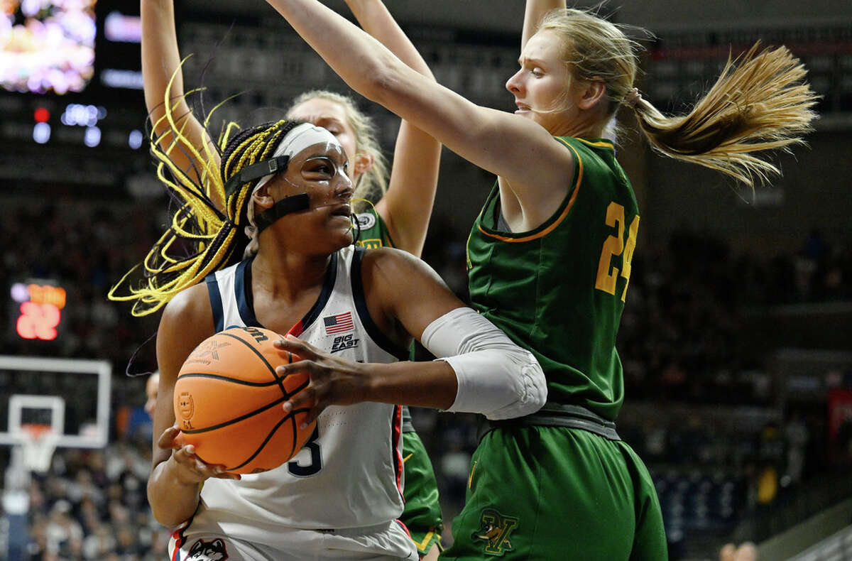 UConn's Aaliyah Edwards, left, is guarded by Vermont's Anna Olson, right, in the first half of a first-round college basketball game in the NCAA Tournament, Saturday, March 18, 2023, in Storrs, Conn. (AP Photo/Jessica Hill)