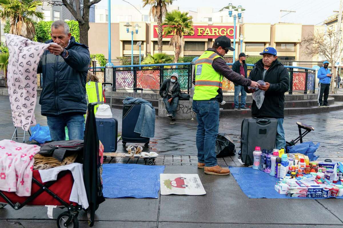 Mission District street vendors pack up items after San Francisco Public Works inspector Alejandro del Calvo learned they did not have a permit.