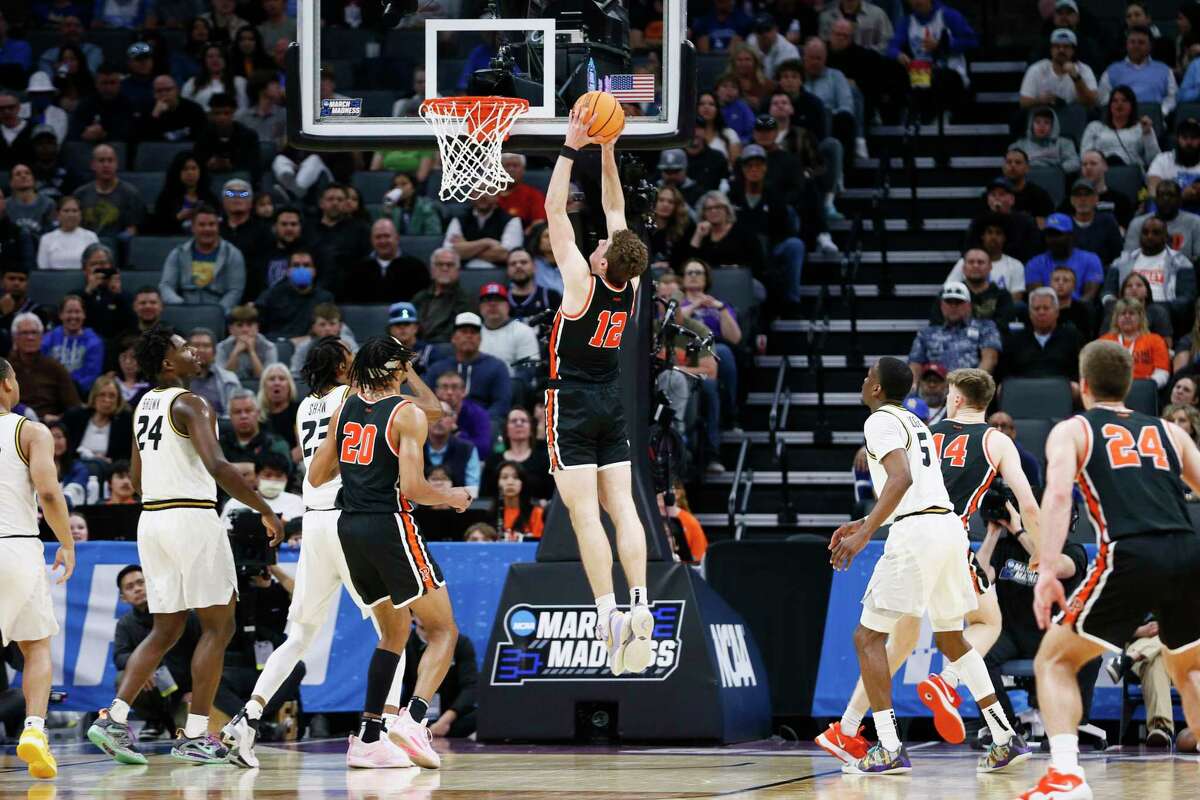 Princeton Tigers forward Caden Pierce (12) dunks against the Missouri Tigers during the second half of a second-round college basketball game in the men's NCAA Tournament, Saturday, March 18, 2023, in Sacramento. The Princeton Tigers won 78-63.