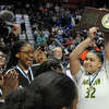 Hamden's Gianna Robert (32) holds up the championship plaque as the team celebrates their win over Fairfield Ludlowe in CIAC basketball championship basketball at Mohegan Sun Arena in Uncasville, Conn., on Saturday March 18, 2023.
