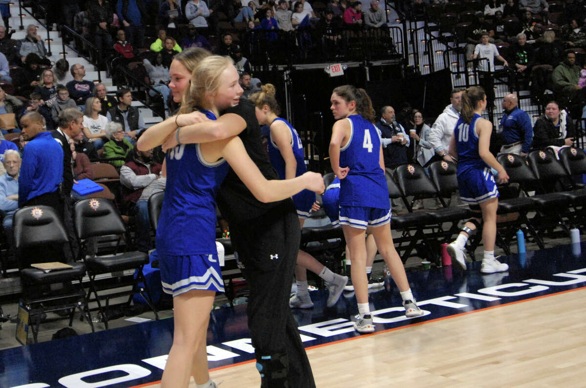 Fairfield Ludlowe's Phoebe Shostak (15) is consoled after being defeated by Hamden in CIAC basketball championship basketball at Mohegan Sun Arena in Uncasville, Conn., on Saturday March 18, 2023.