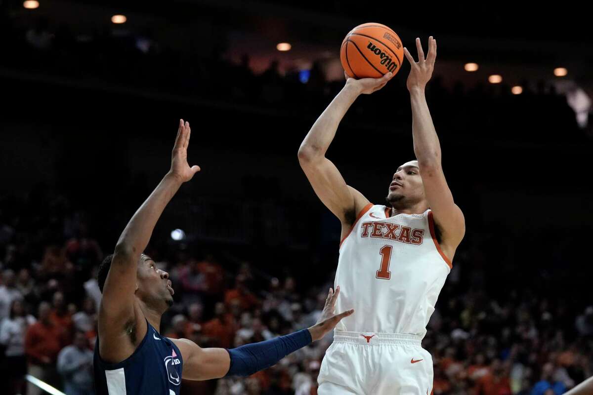Texas forward Dylan Disu (1) shoots over Penn State forward Kebba Njie, left, in the first half of a second-round college basketball game in the NCAA Tournament, Saturday, March 18, 2023, in Des Moines, Iowa.