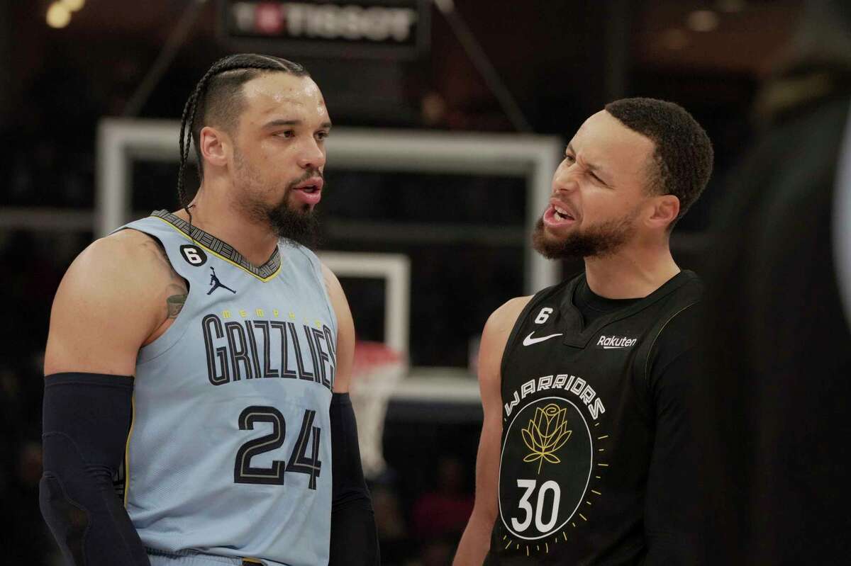 Grizzlies forward Dillon Brooks (left) and Warriors guard Stephen Curry have words in the first half of Saturday's game in Memphis.