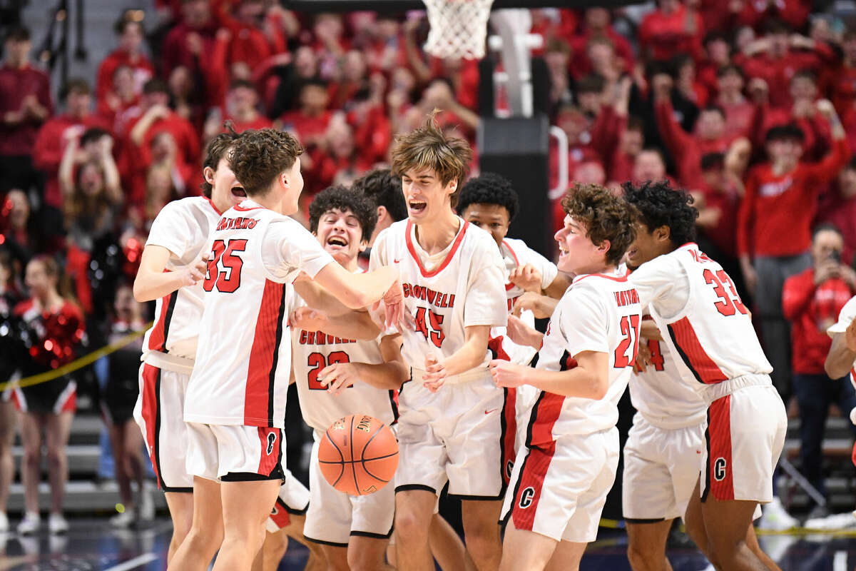 The Cromwell Panthers celebrate winning the 2023 CIAC Division IV Boys Basketball Championship at Mohegan Sun Arena, March 19, 2023