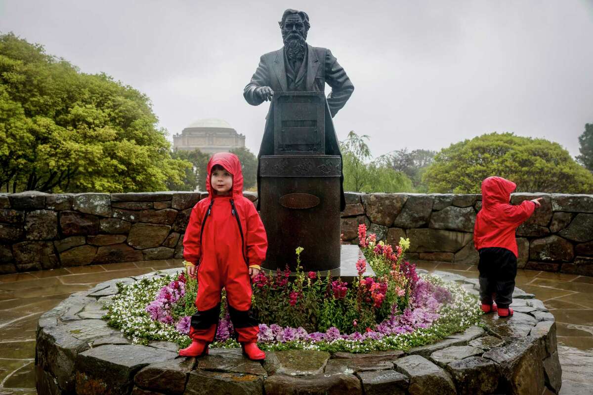 Connor Evans, 3, plays in the rain on the last day of winter with his brother, Xander Evans, 2, at the Letterman Digital Arts Center in San Francisco.