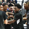 WCA's Andrew Williams, center, celebrates with teammates after No. 2 Waterbury Career Academy's 74-58 win over No. 1 Bloomfield in the CIAC Divison III boys basketball championship at Mohegan Sun Arena in Uncasville, Conn. Sunday, March 19, 2023.