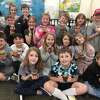 Students in Ben Mauntler's second grade class at Onekama Consolidated Schools show off jars of the maple syrup they made.