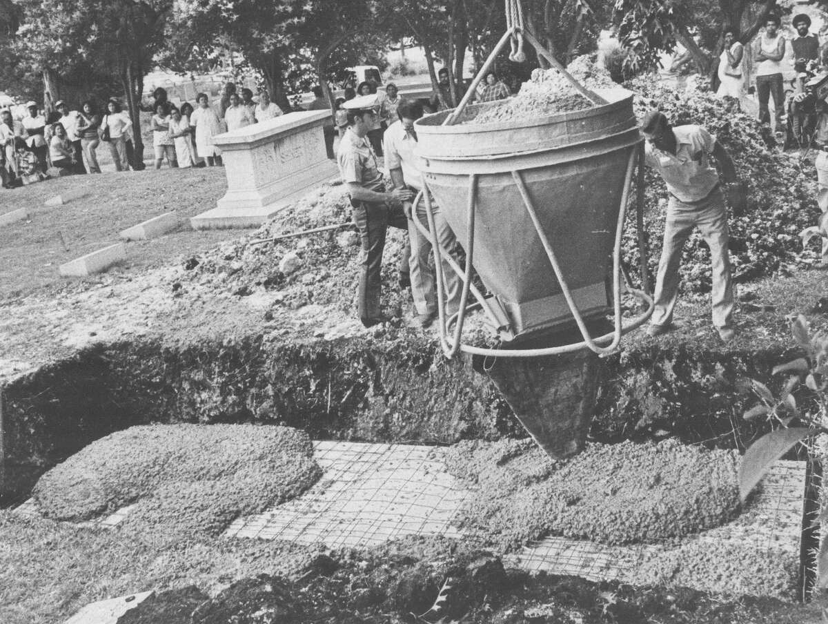 In questa foto del file del maggio 1977, il cemento che viene scaricato sopra la scatola sulla tomba di Sandra West contiene la sua Ferrari con West al posto di guida, come aveva richiesto.  Foto del file Express-News di Joe Barrera Jr.