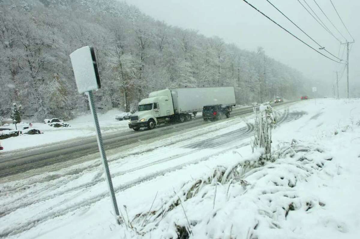 A truck passes over Sherburne Pass on Route 4 in Killington, Vt., on Friday, Oct. 15, 2010, as an unexpected snowstorm dumped a blanket of snow on higher elevations in Vermont. (Associated Press/Rutland Herald, Vyto Starinskas)