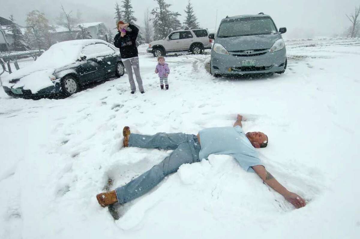 Roy Webster of Rutland, Vt., drove his wife, Amanda, and his daughter, Raegan, who is almost 2 years old, up to Killington Ski Area on Friday, Oct. 15, 2010, to make snow angels during an unexpected snowstorm. Amanda takes photos. Kilington reported five to 10 inches of snow. (Associated Press/Rutland Herald, Vyto Starinskas)