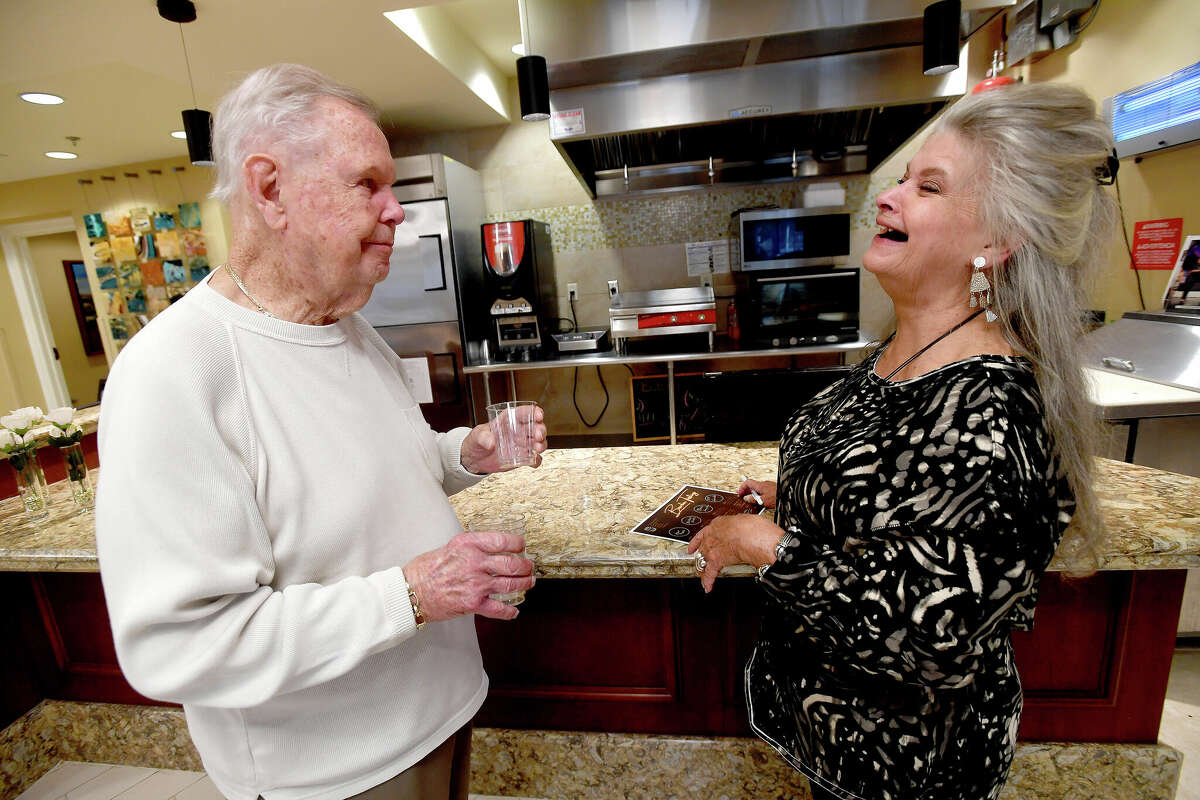 Polly Ashworth offers a toast as she and father Howard Cobb sample bourbons during a BBQ and Bourbon social event at Calder Woods in Beaumont Tuesday. Photo made Tuesday, March 21, 2023 Kim Brent/Beaumont Enterprise