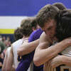 Frankfort junior Bryce Plesha (center) hugs sophomore Carter Kerby after a win against Hillman on March 21, 2023 at Gaylord High School. The Panthers defeated the Tigers 59-57 to advance to the state semifinals. 